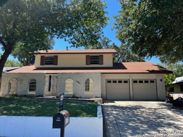 view of front of house with a garage and a front yard