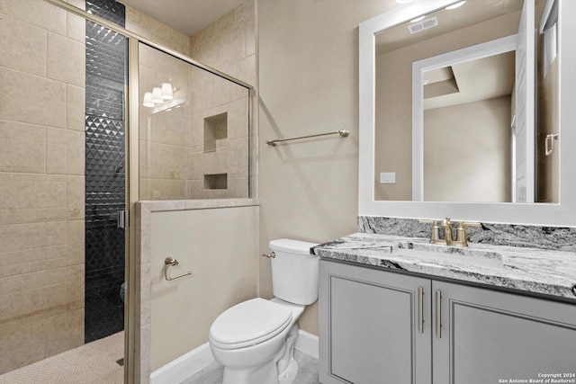 full bath with visible vents, toilet, a stall shower, and vanity