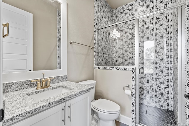 bathroom with vanity, toilet, and an enclosed shower