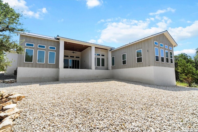 back of property with ceiling fan