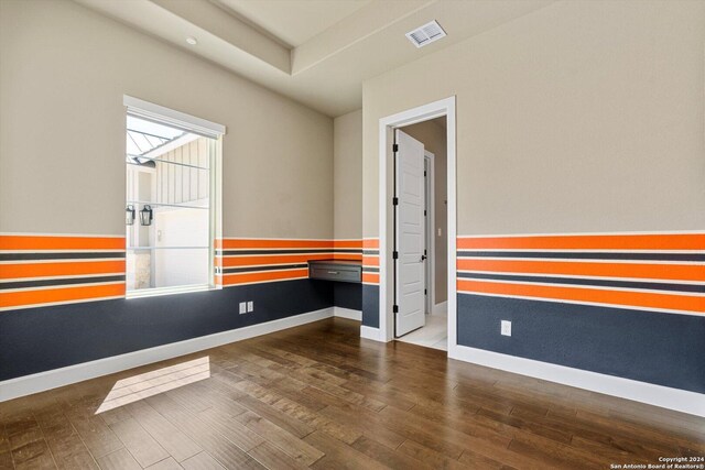 spare room featuring dark hardwood / wood-style flooring