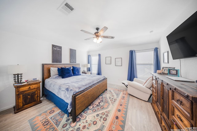 bedroom with light hardwood / wood-style flooring and ceiling fan