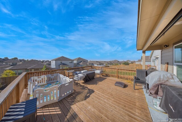 wooden deck featuring a grill