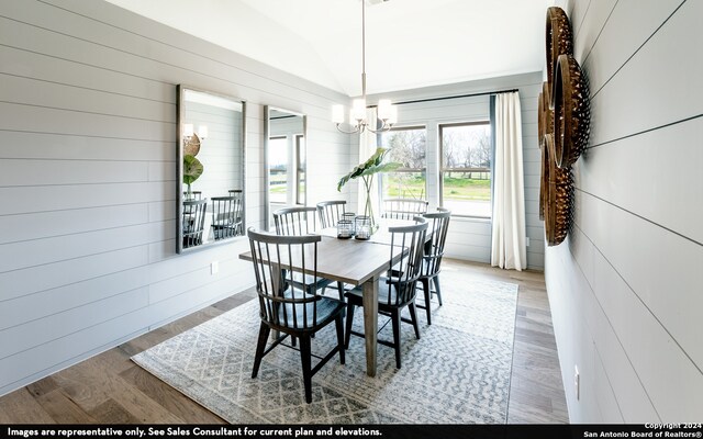 dining room featuring wood-type flooring and a chandelier