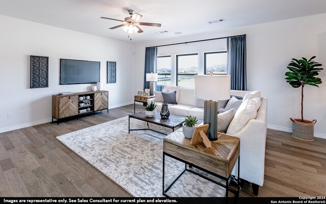 living room with ceiling fan and hardwood / wood-style flooring