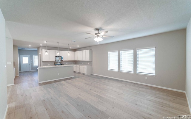 14735 Sycamore Xing, San Antonio, TX 78252 - kitchen with tasteful backsplash, electric stove, a sink, white cabinets, and visible vents