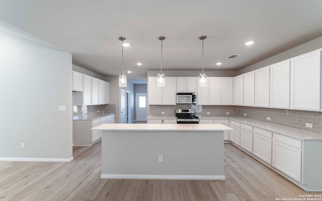 14735 Sycamore Xing, San Antonio, TX 78252 - kitchen with white cabinets, stainless steel appliances, a sink, wood finished floors, and a breakfast bar area