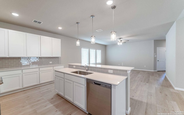 14735 Sycamore Xing, San Antonio, TX 78252 - kitchen featuring light wood-style floors, white cabinetry, a kitchen bar, backsplash, and appliances with stainless steel finishes
