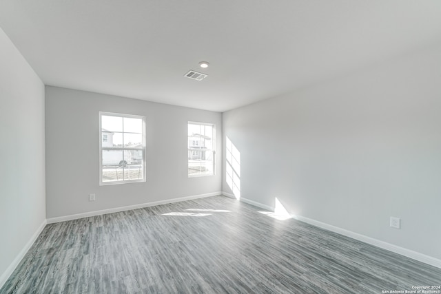 empty room with dark hardwood / wood-style flooring