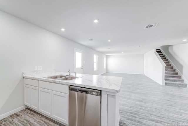 kitchen featuring light hardwood / wood-style flooring, dishwasher, kitchen peninsula, sink, and white cabinets