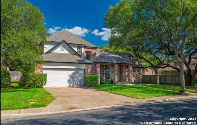 front facade with a garage and a front lawn