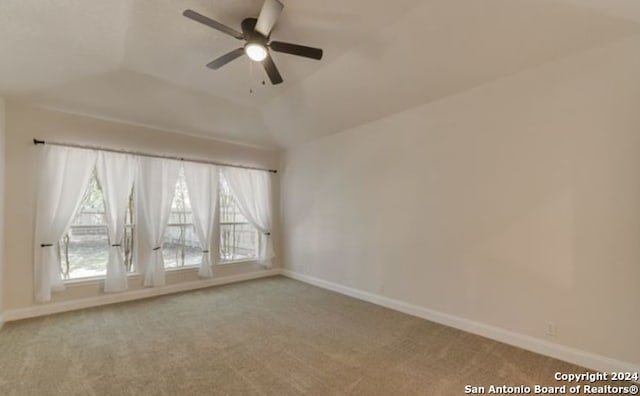 unfurnished room with light colored carpet, ceiling fan, and lofted ceiling