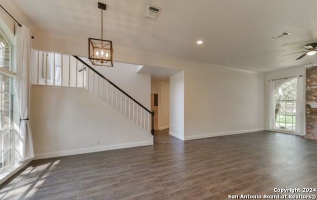 16414 Inwood Cv, San Antonio, TX 78248 - unfurnished living room with visible vents, wood finished floors, stairway, and ceiling fan with notable chandelier