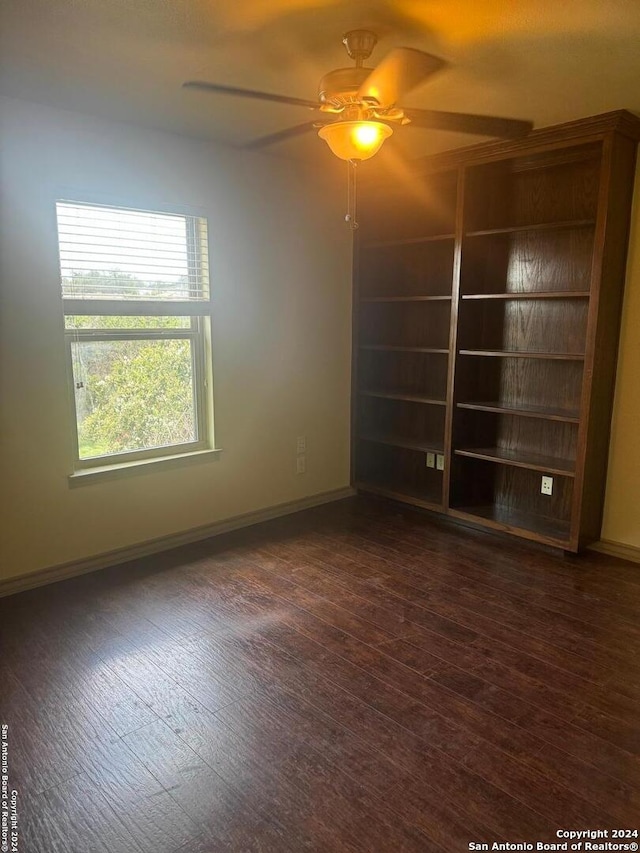 unfurnished room featuring dark hardwood / wood-style flooring and ceiling fan