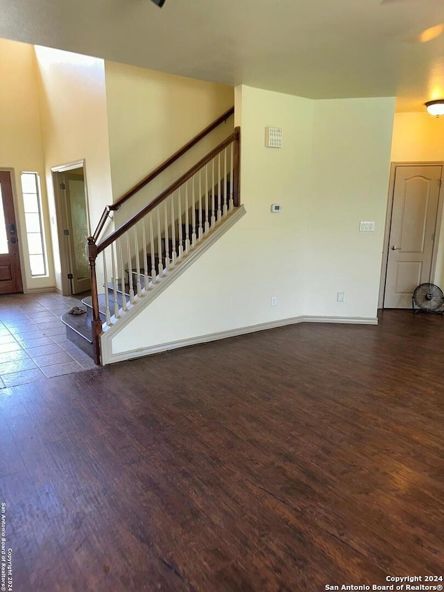 unfurnished living room featuring dark wood-type flooring