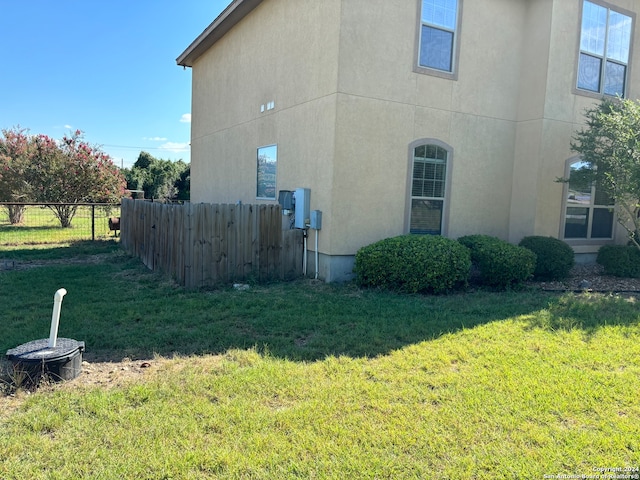 view of side of property featuring a yard