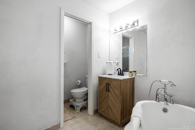 212 San Saba, Portland, TX 78374 - bathroom with a freestanding tub, toilet, vanity, and tile patterned flooring