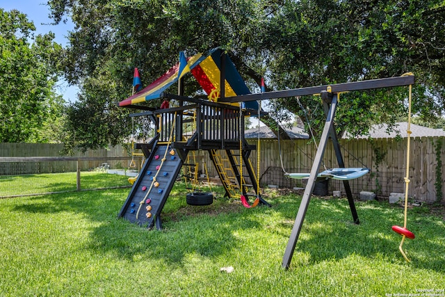 view of jungle gym featuring a lawn