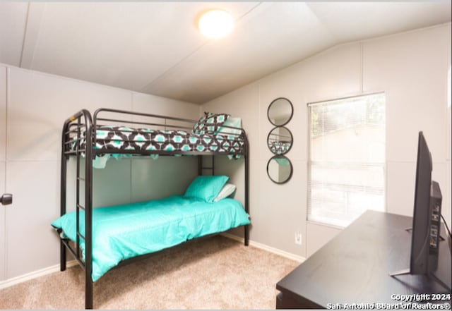 carpeted bedroom featuring vaulted ceiling