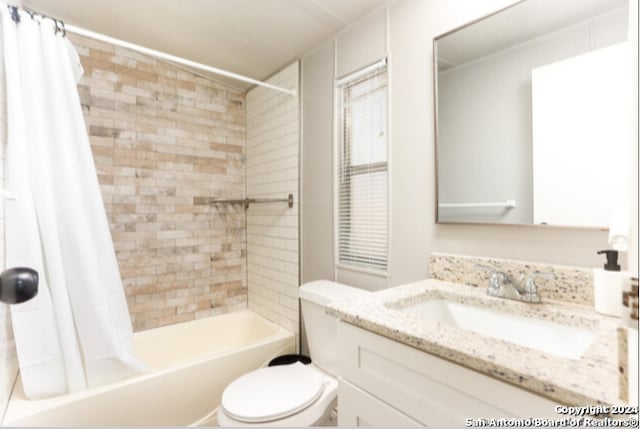 full bathroom featuring shower / bath combo, toilet, and vanity