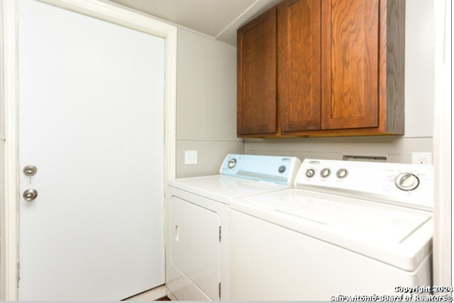 laundry room with cabinets and washer and dryer