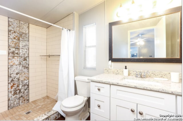 bathroom with ceiling fan, curtained shower, vanity, and toilet