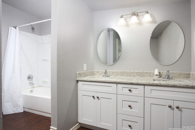 bathroom featuring vanity,  shower combination, and hardwood / wood-style flooring