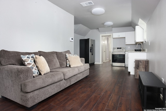 living room featuring sink, dark wood-type flooring, and lofted ceiling