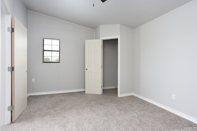 unfurnished bedroom featuring light carpet