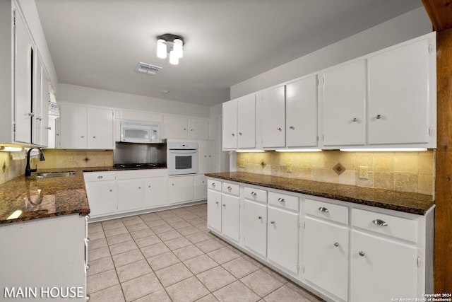 kitchen featuring white cabinetry, white appliances, and sink