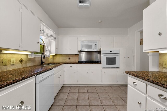 kitchen with sink, white appliances, and white cabinets