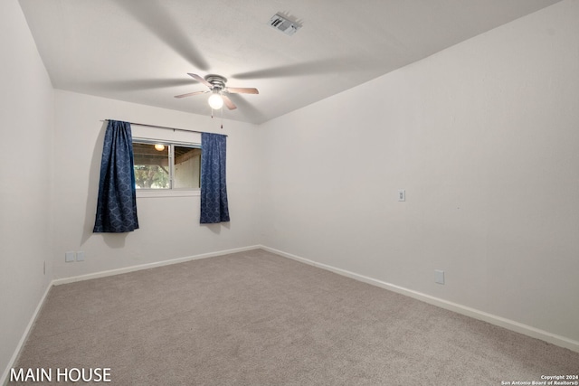 empty room featuring ceiling fan and carpet floors