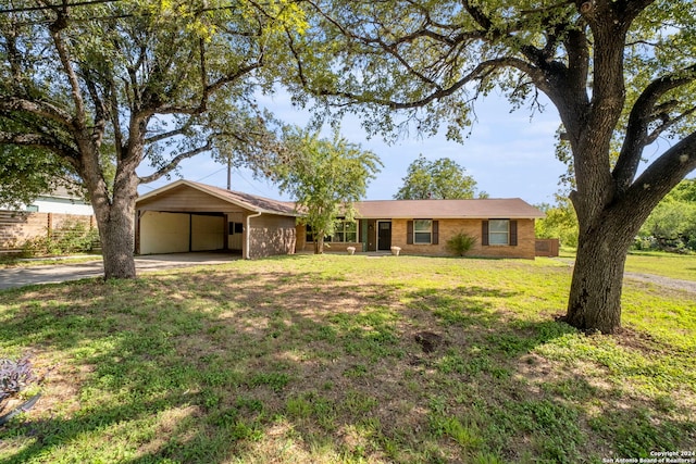 ranch-style house with a front yard and a carport