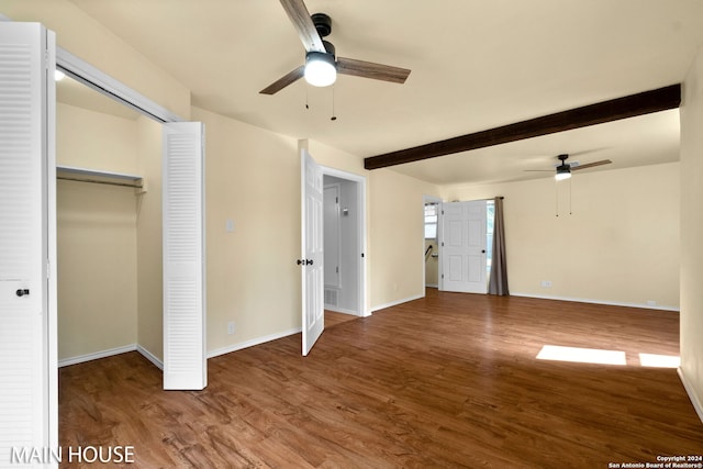 unfurnished bedroom with a closet, ceiling fan, hardwood / wood-style floors, and beam ceiling