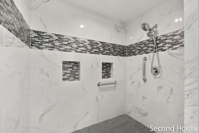 bathroom with tiled shower