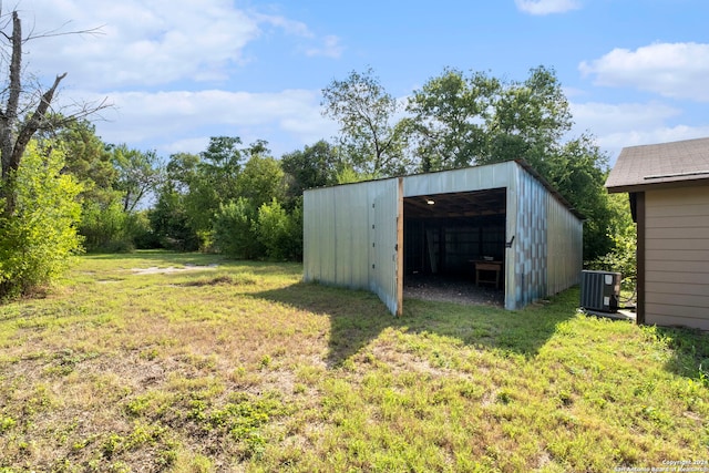 view of yard with an outbuilding and central air condition unit