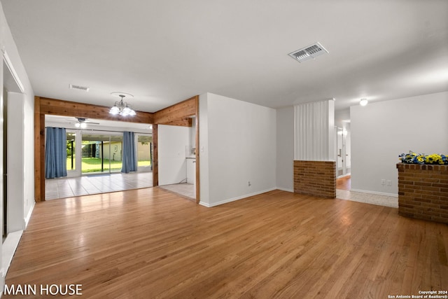 interior space featuring light wood-type flooring and an inviting chandelier