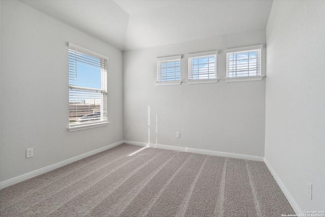 empty room featuring carpet floors, a healthy amount of sunlight, and baseboards