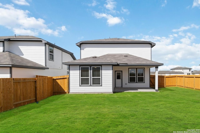 back of house with a yard, a patio area, and a fenced backyard