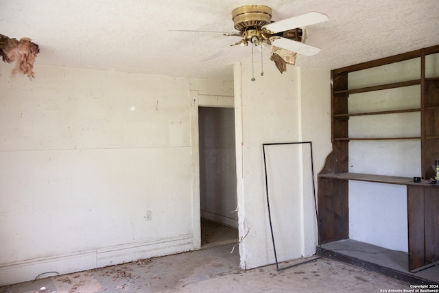 interior space featuring a textured ceiling, concrete flooring, and ceiling fan