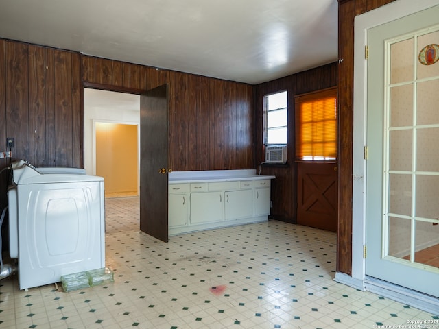 kitchen with washer / clothes dryer and wooden walls