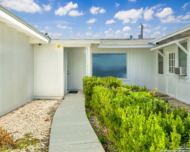 doorway to property featuring cooling unit