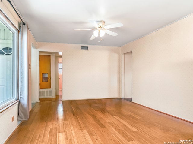 unfurnished room featuring light hardwood / wood-style flooring and ceiling fan