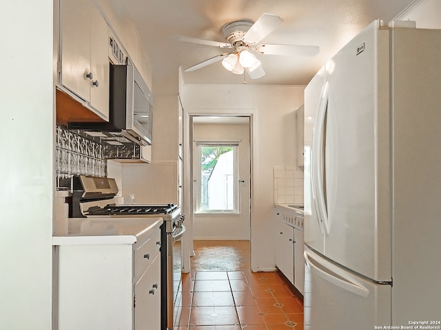 kitchen featuring white cabinetry, stainless steel appliances, ceiling fan, and decorative backsplash