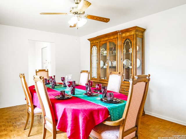 dining room with parquet floors and ceiling fan