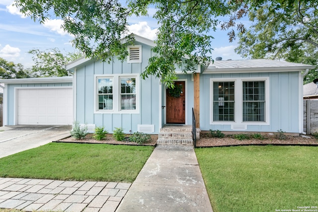 view of front of property featuring a garage and a front yard