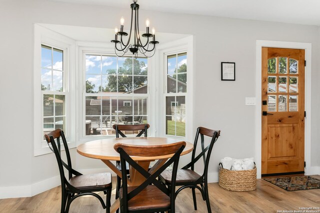 dining space with a chandelier and light hardwood / wood-style floors