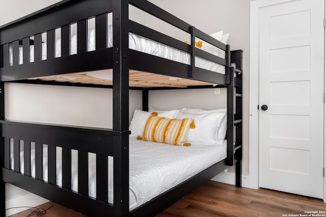 bedroom with dark hardwood / wood-style flooring