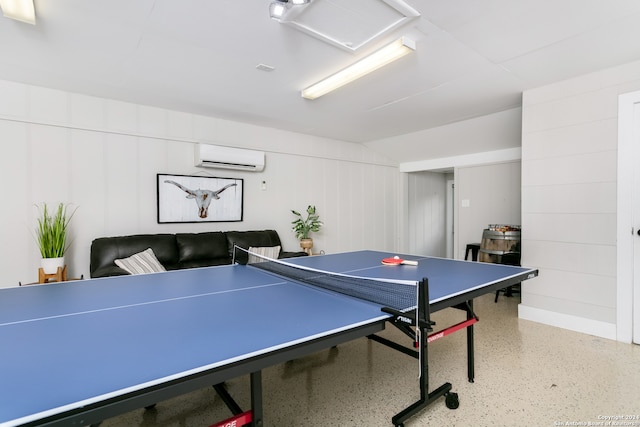 playroom with an AC wall unit and wooden walls