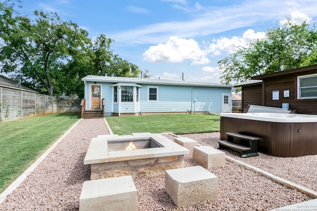 view of yard featuring a fire pit and a hot tub